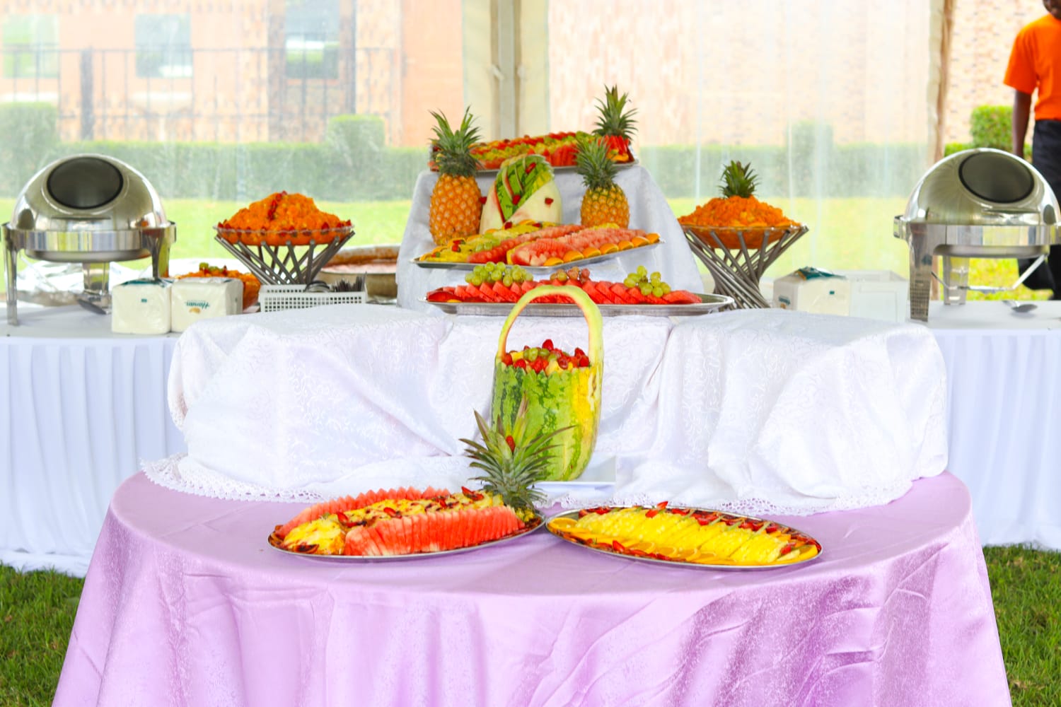 Fruit platters and a carved watermelon basket on the buffet table