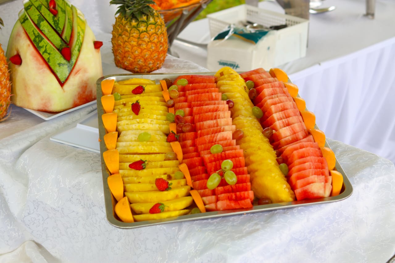 Rows of pineapple and watermelon with grapes and strawberries