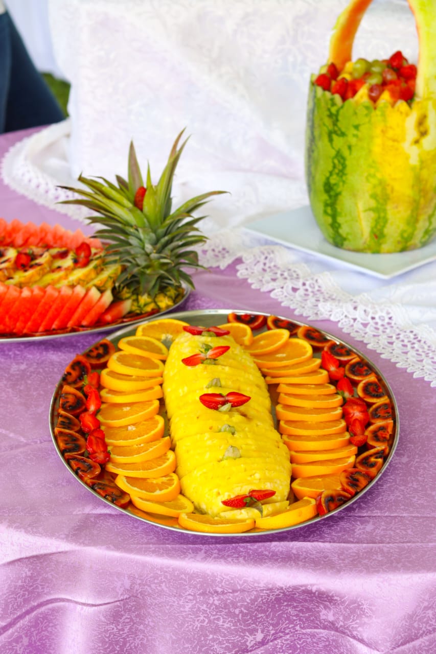 Pineapple slices surrounded by oranges and fruit garnish