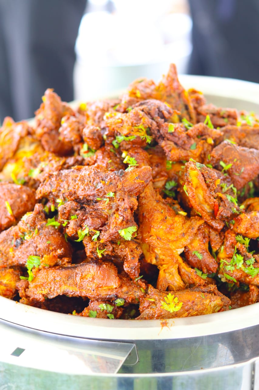 A platter of chicken with herb garnish